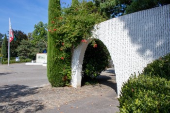 Musée Olympique de Lausanne avec des une petite arcade ornée de fleurs et de verdures